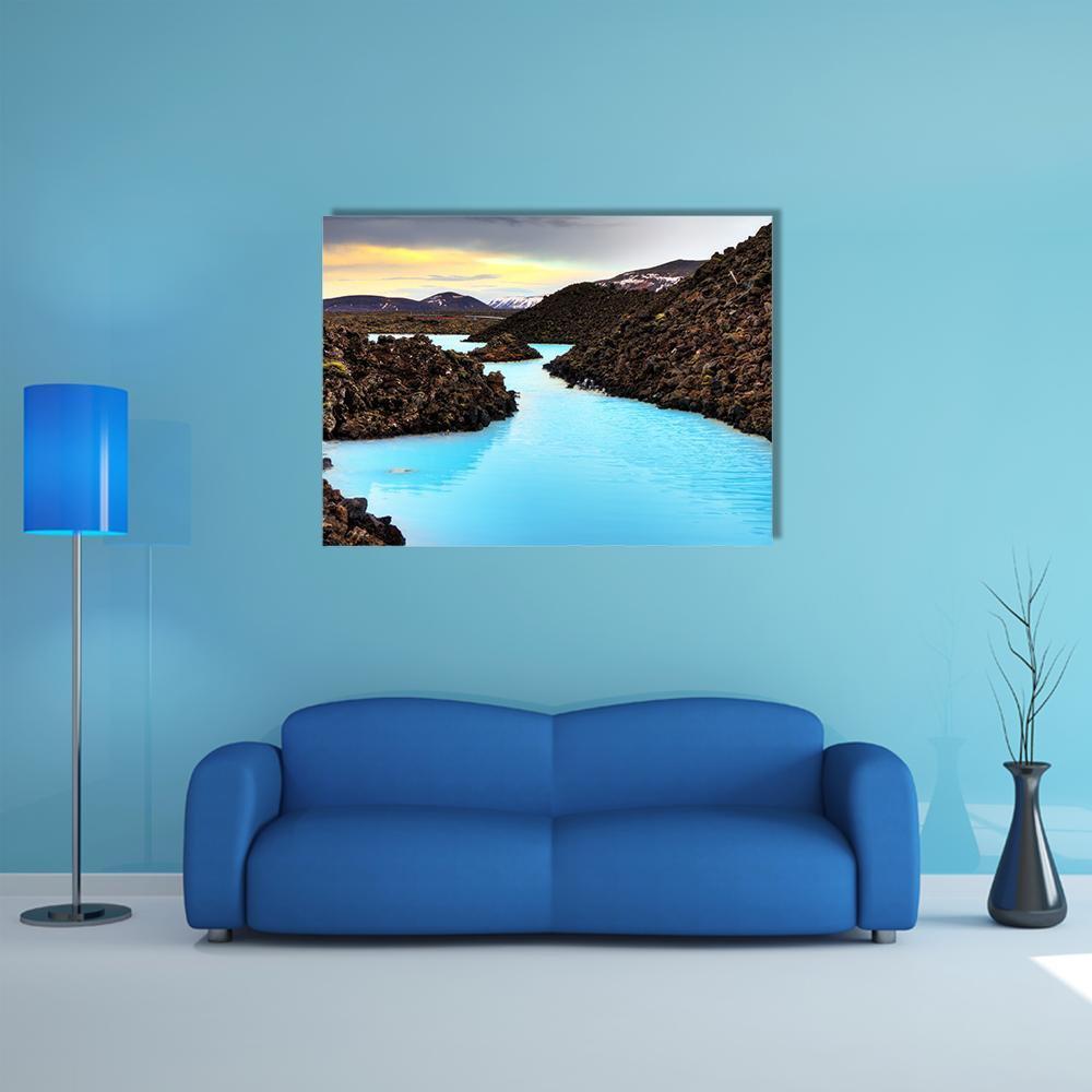 Blue Lagoon in Lava Field Canvas Wall Art in black, brown and blue, single panel hung on a wall