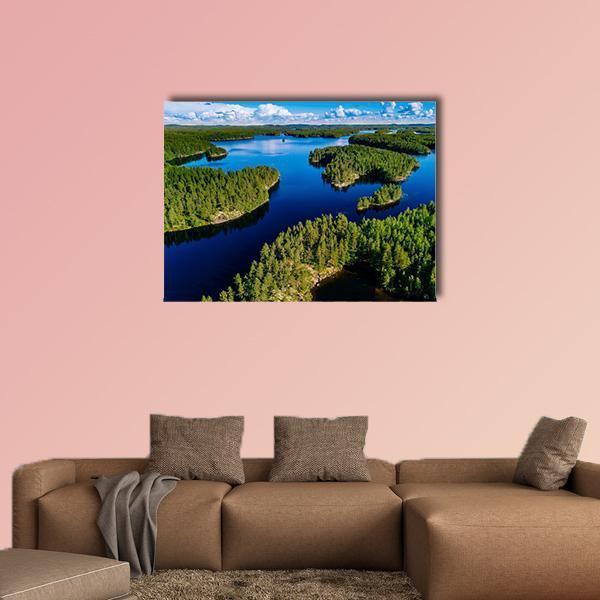Blue Lake in Green Forest Canvas Wall Art in green and blue, single panel hung on a wall