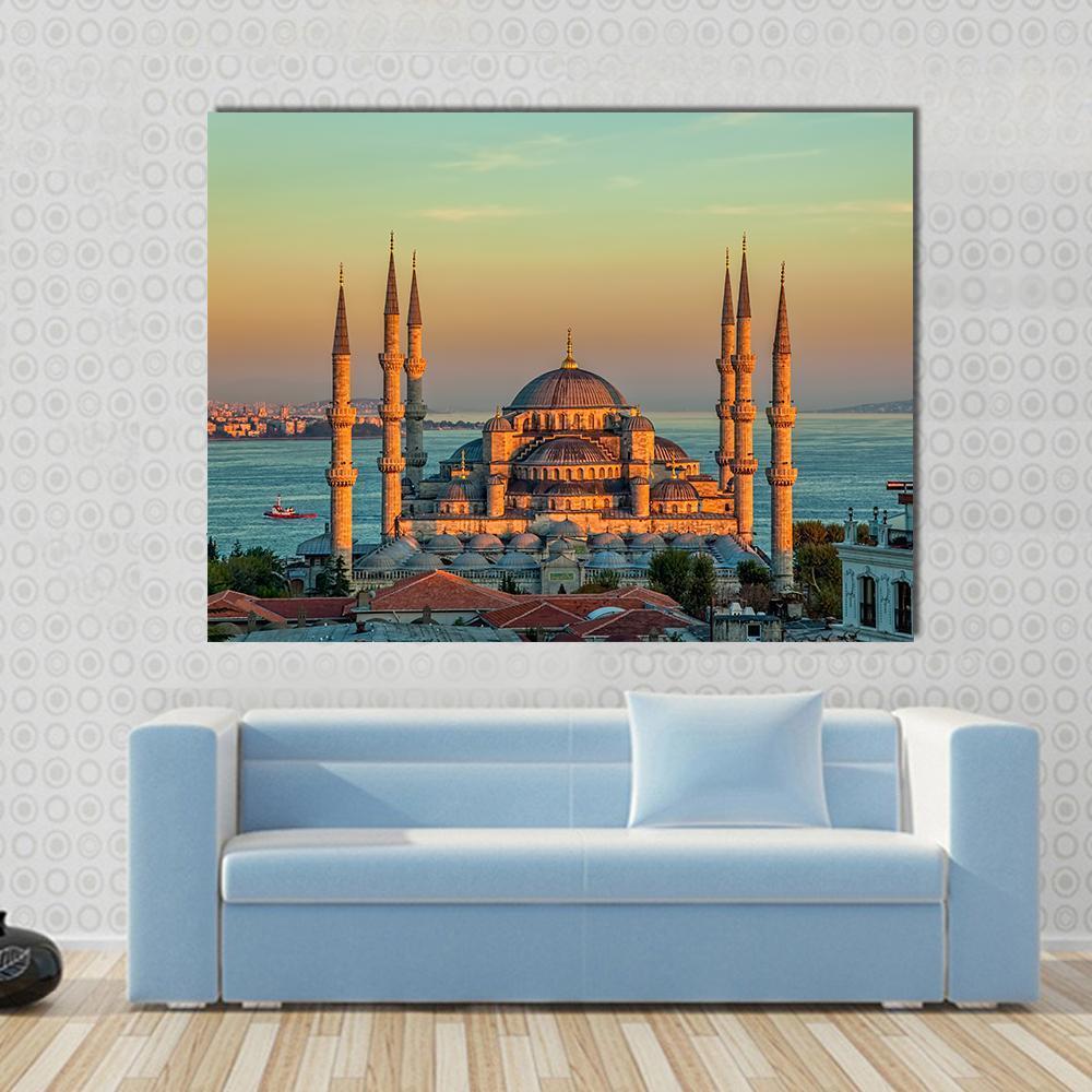 Blue Mosque at Sunset Canvas Wall Art in orange, yellow and blue, single panel hung on a wall