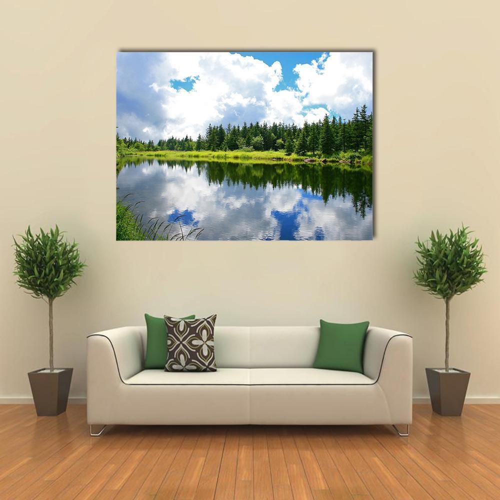 Blue Mountain Lake with Forest Reflection Canvas Wall Art in white, green and blue, single panel hung on a wall