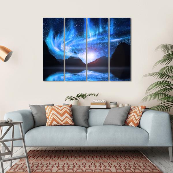 Blue Northern Lights Over Mountains Canvas Wall Art in black and blue, hung on a wall