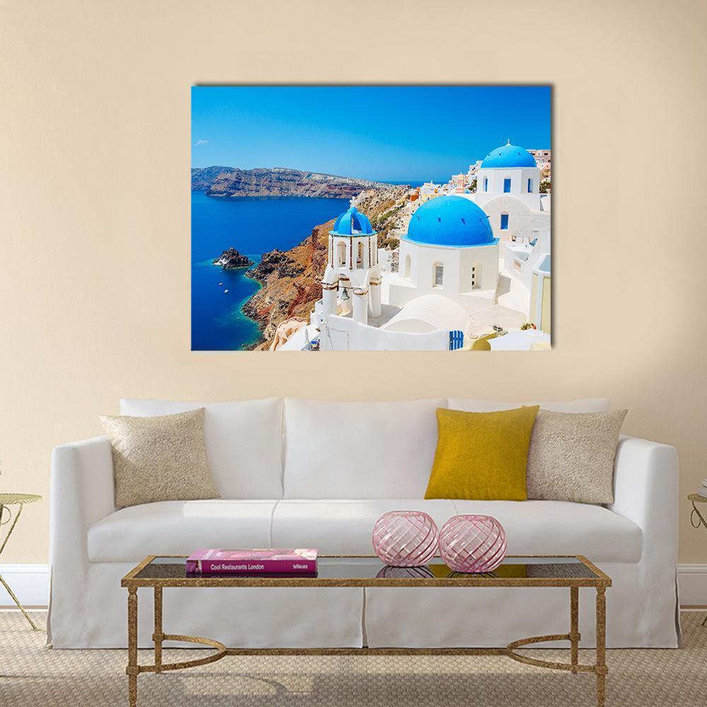 Blue Domed Church in Santorini Canvas Wall Art in white and blue, single panel hung on a wall