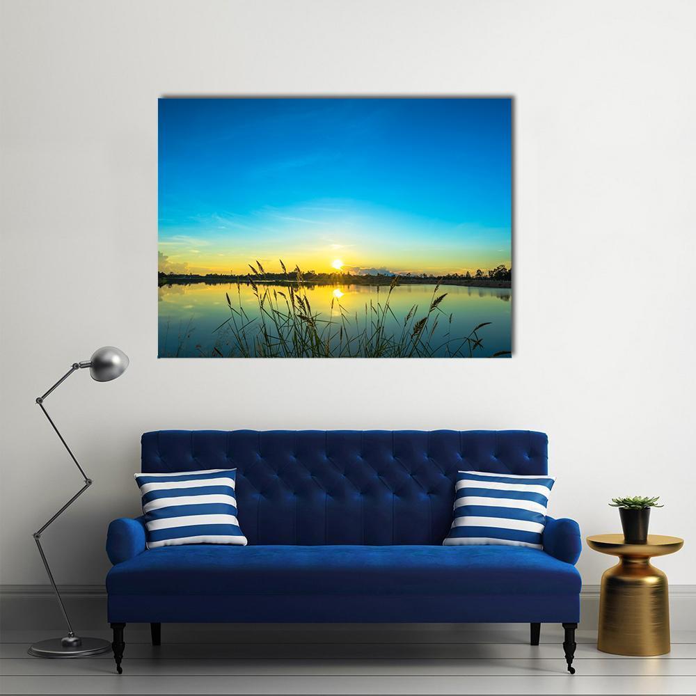 Blue Sky at Calm Lake Canvas Wall Art in yellow and blue, single panel hung on a wall