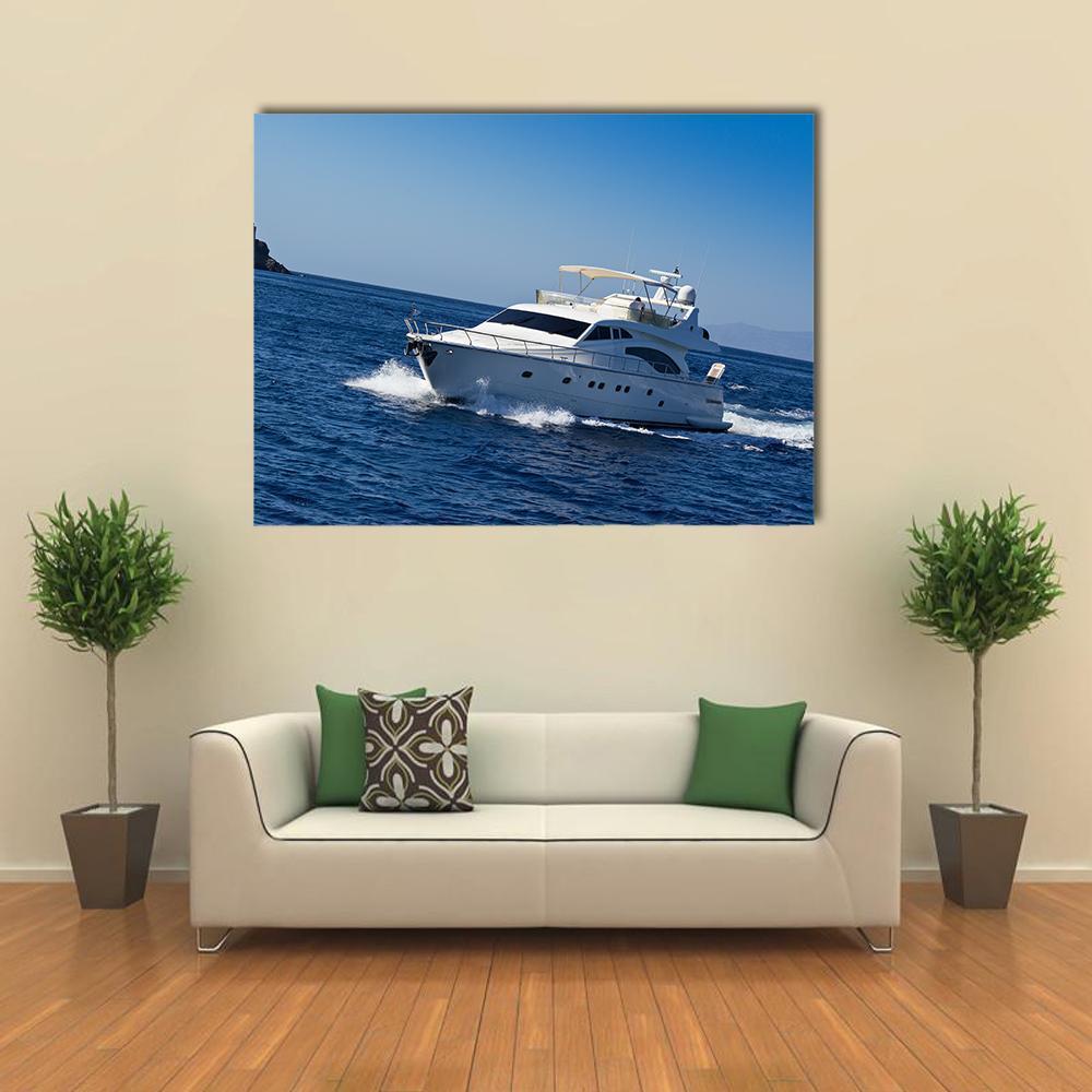 Yacht in Bright Blue Ocean Canvas Wall Art in white and blue, single panel hung on a wall
