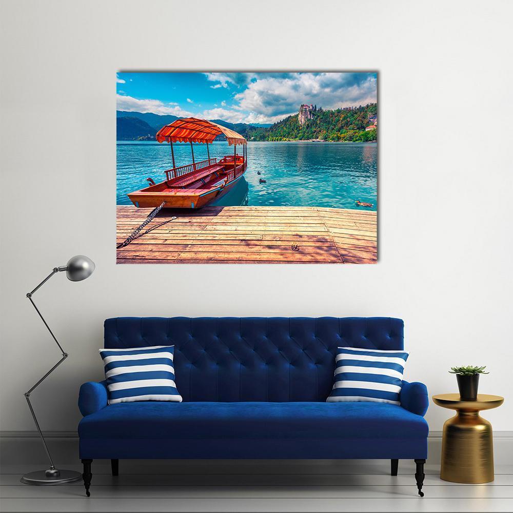 Boat on Lake with Castle and Mountains Canvas Wall Art in brown, green and blue, single panel hung on a wall