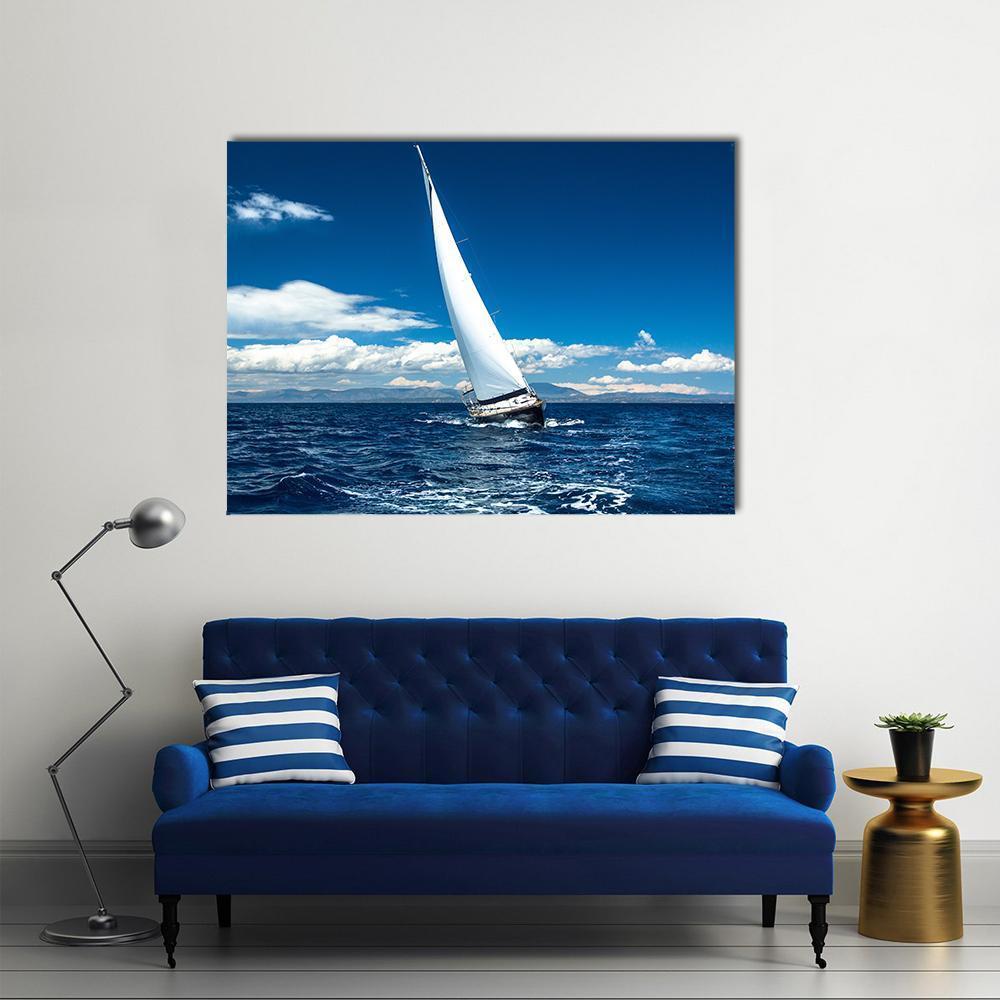 Sailboat in a Regatta Canvas Wall Art in white and blue, single panel hung on a wall
