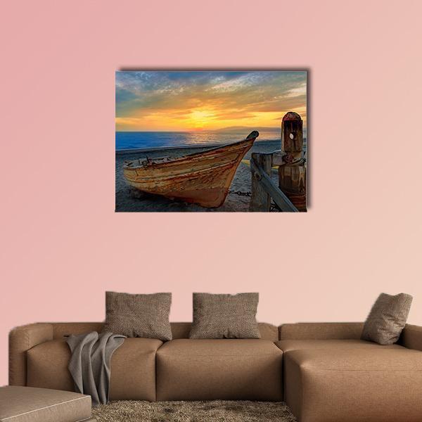 Old Wooden Boat at Sunset Beach Canvas Wall Art in brown, orange and blue, single panel hung on a wall