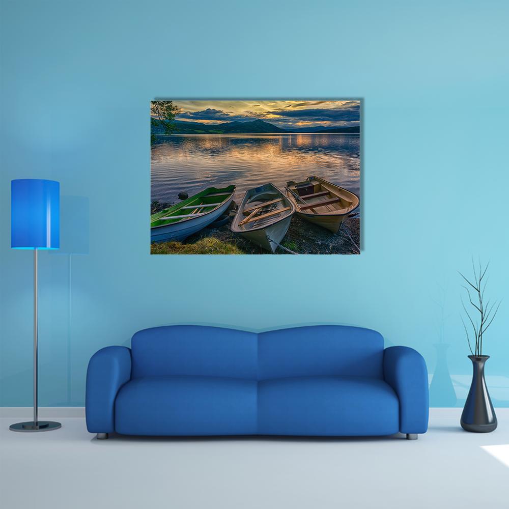Three Boats Near Silence Lake Canvas Wall Art in brown, orange and blue, single panel hung on a wall