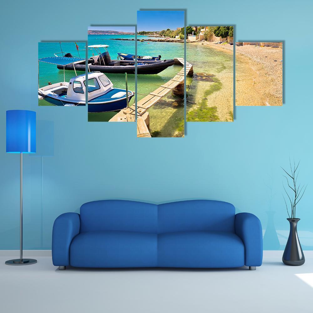 Boats on Turquoise Beach Canvas Wall Art in beige, green and blue, 5 panel Star layout hung on a wall