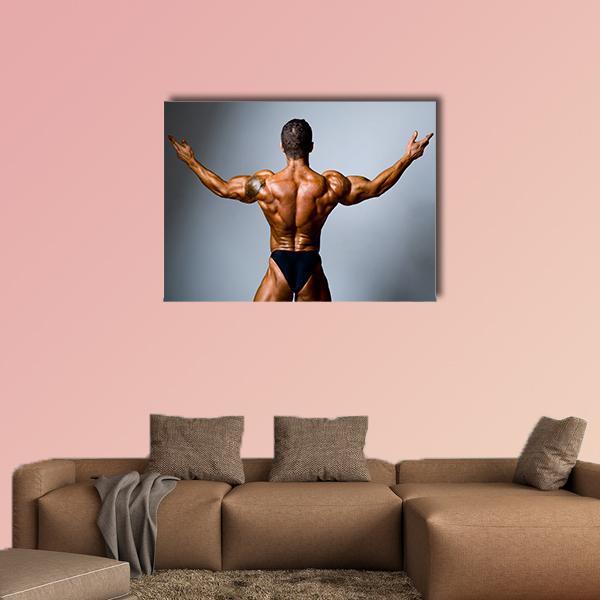 Back-facing Bodybuilder with Outstretched Arms Canvas Wall Art in black, gray and brown, single panel hung on a wall