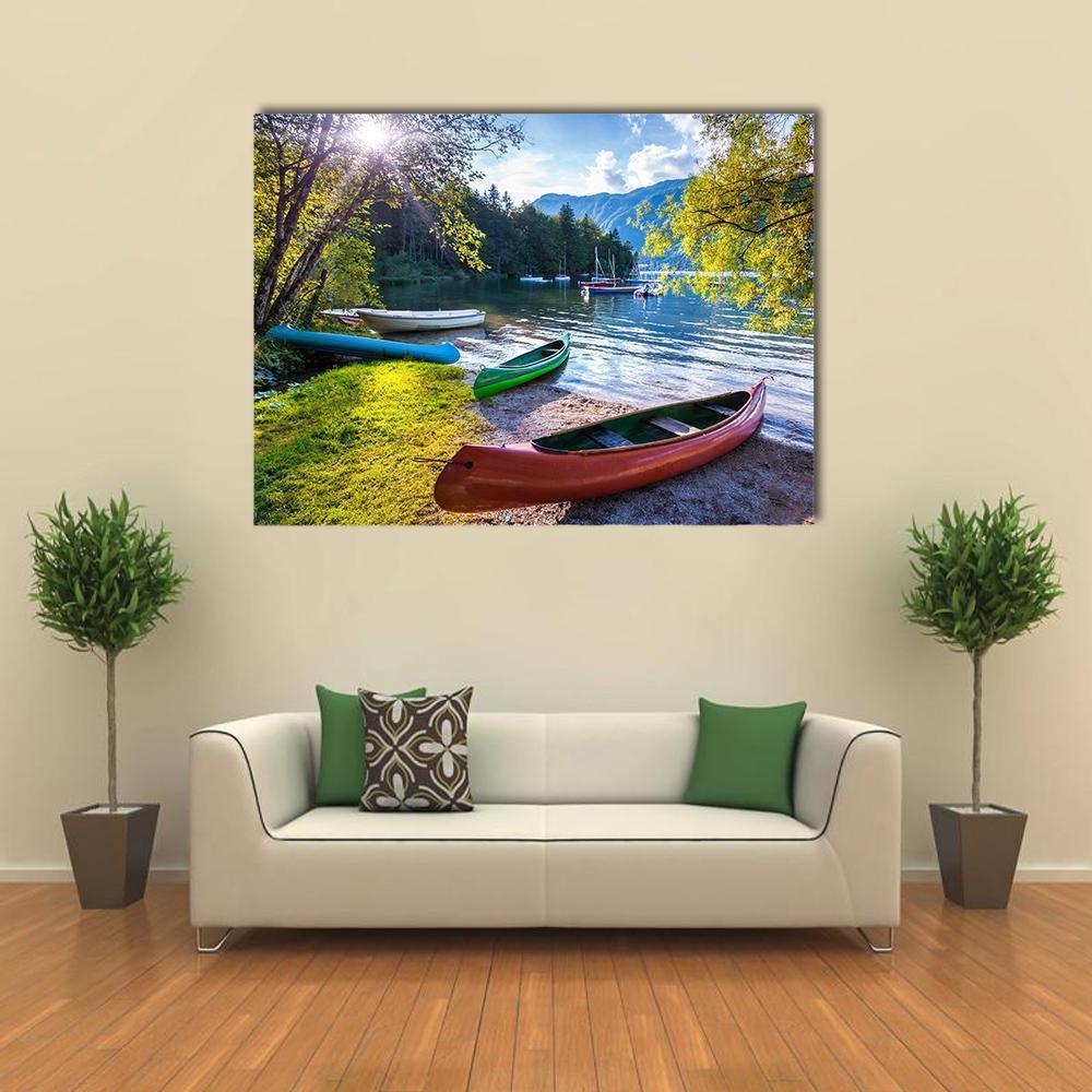Bohinj Lake with Four Canoes Canvas Wall Art in green and blue, single panel hung on a wall