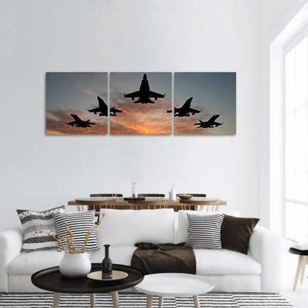 Five Jets in V-formation at Sunset Panoramic Canvas Wall Art in black, gray and orange, hung on a wall