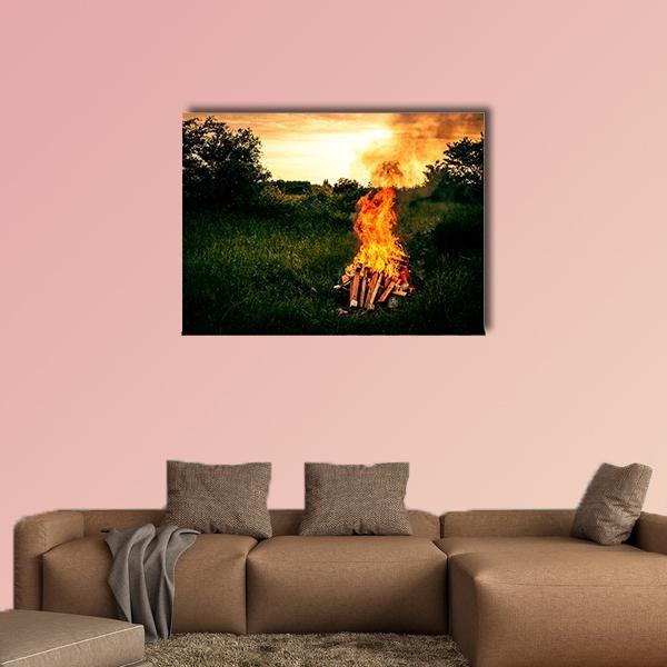 Bonfire at Camp Canvas Wall Art in orange, yellow and green, single panel hung on a wall