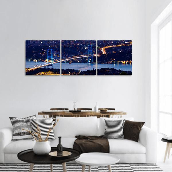 Bosporus Bridge Night Skyline Panoramic Canvas Wall Art in black, yellow and blue, hung on a wall