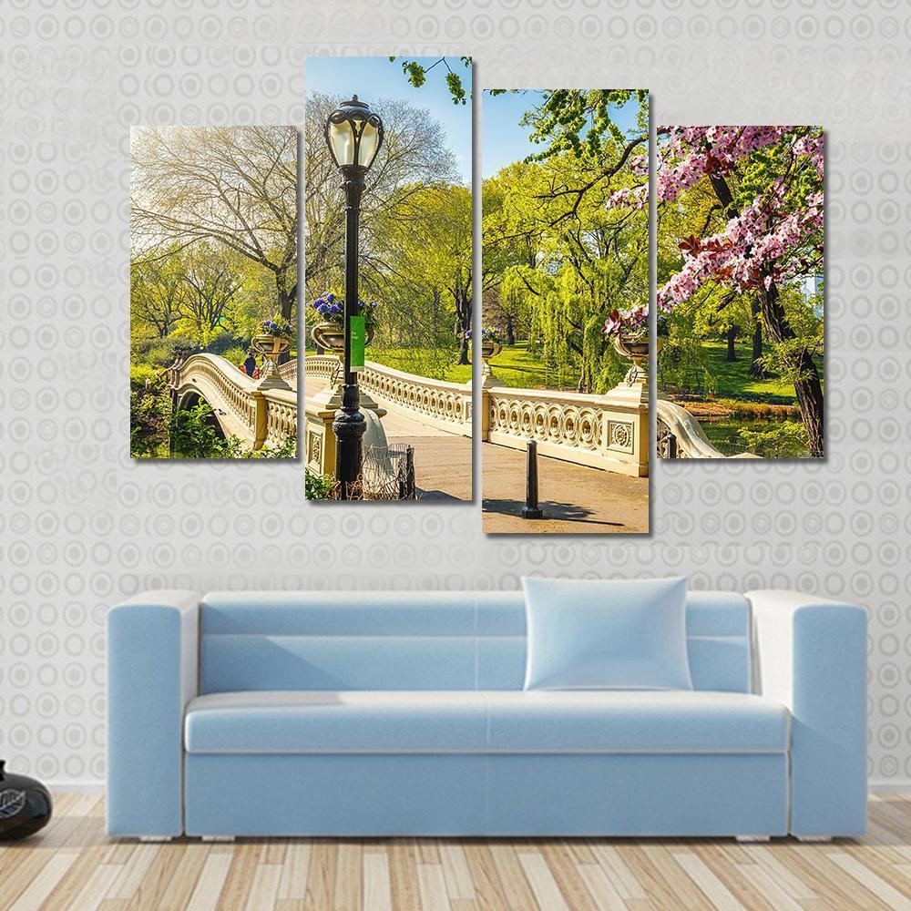 Bow Bridge in Central Park Canvas Wall Art in beige, green and blue, single panel hung on a wall