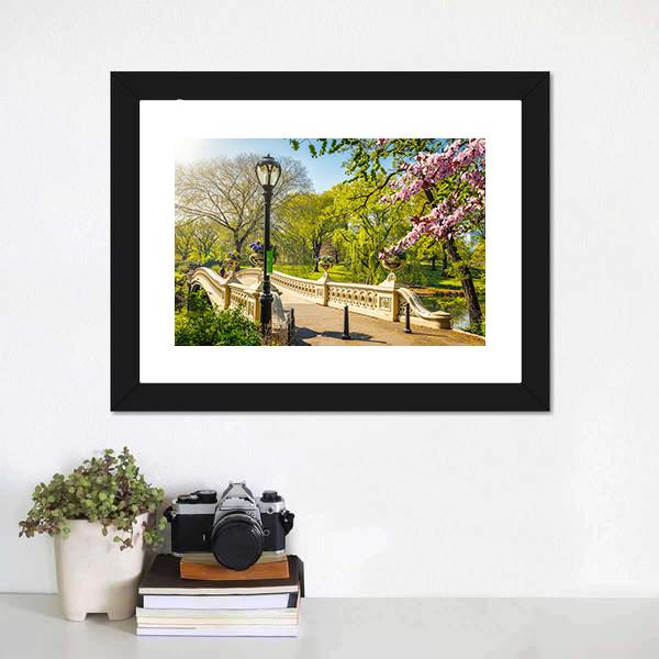 Bow Bridge in Central Park Canvas Wall Art in beige, green and blue, single panel hung on a wall