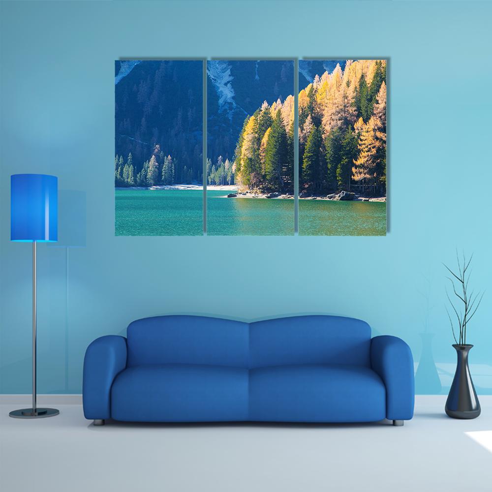 Turquoise Autumn Lake with Snow-capped Mountains Canvas Wall Art in yellow, green and blue, 3 panel horizontal set hung on a wall