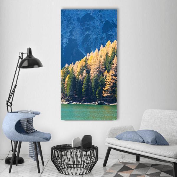 Autumn at Braies Lake Vertical Canvas Wall Art in yellow, green and blue, single vertical panel hung on a wall
