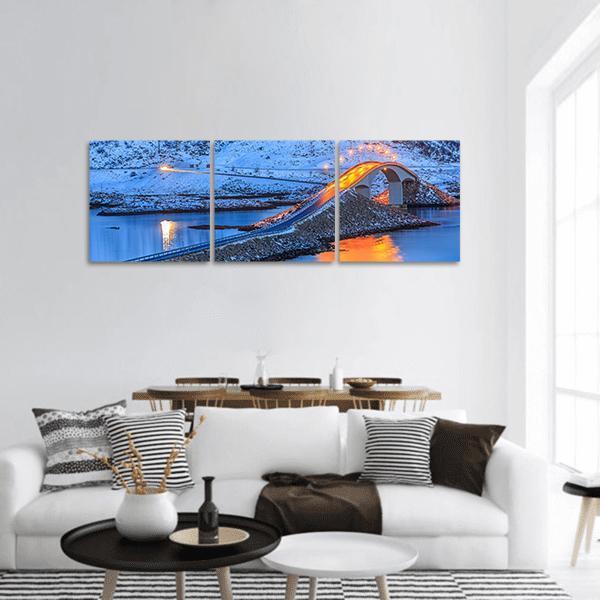 Arched Coastal Bridge with Light Trails Panoramic Canvas Wall Art in white, orange and blue, hung on a wall