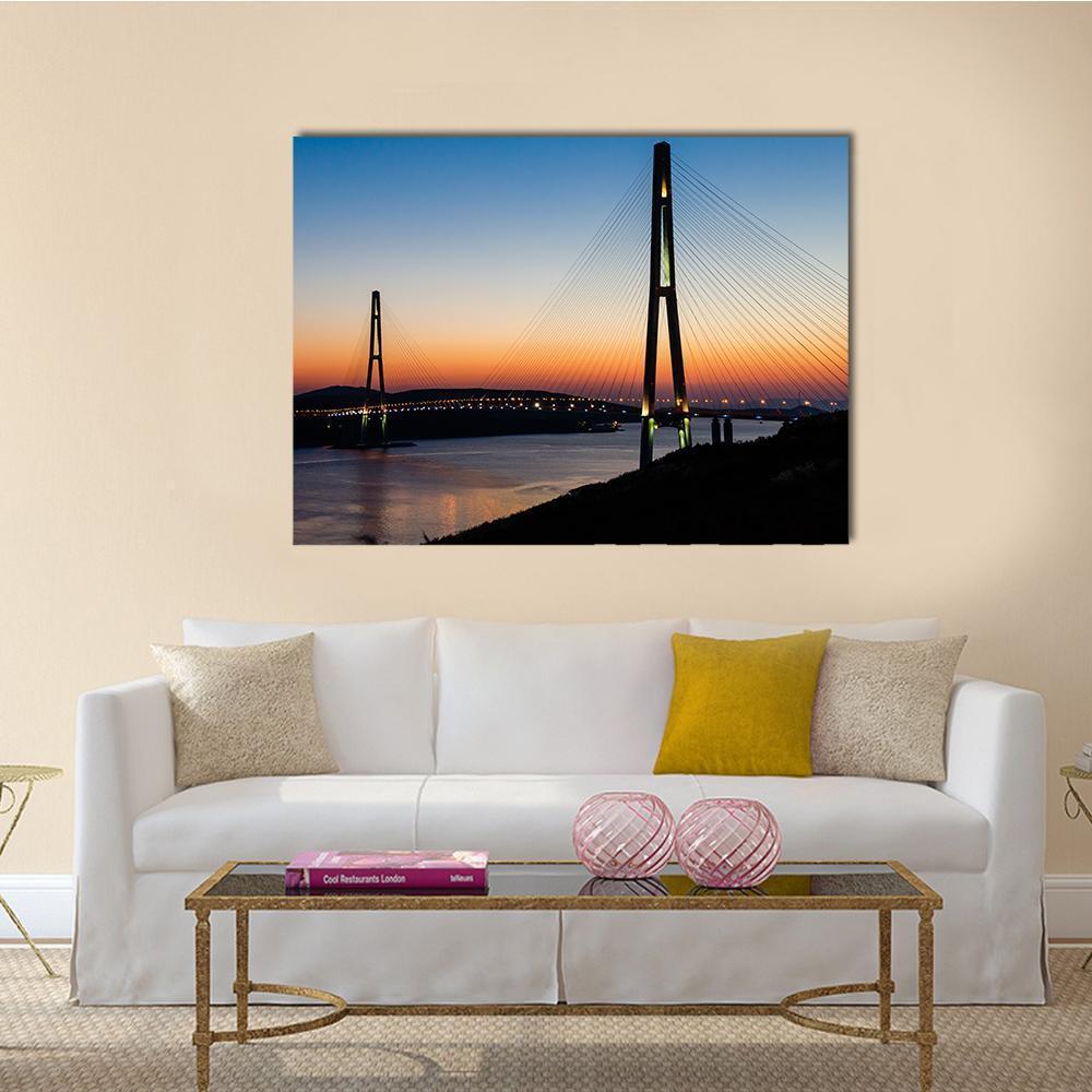 Cable-stayed Bridge at Twilight Canvas Wall Art in black, orange and blue, single panel hung on a wall