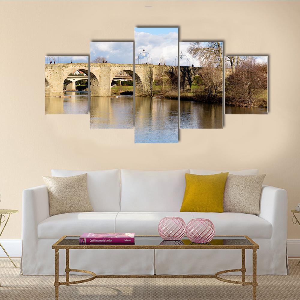 Stone Bridge Over Lake in France Canvas Wall Art in gray, beige and blue, 5 panel Star layout hung on a wall