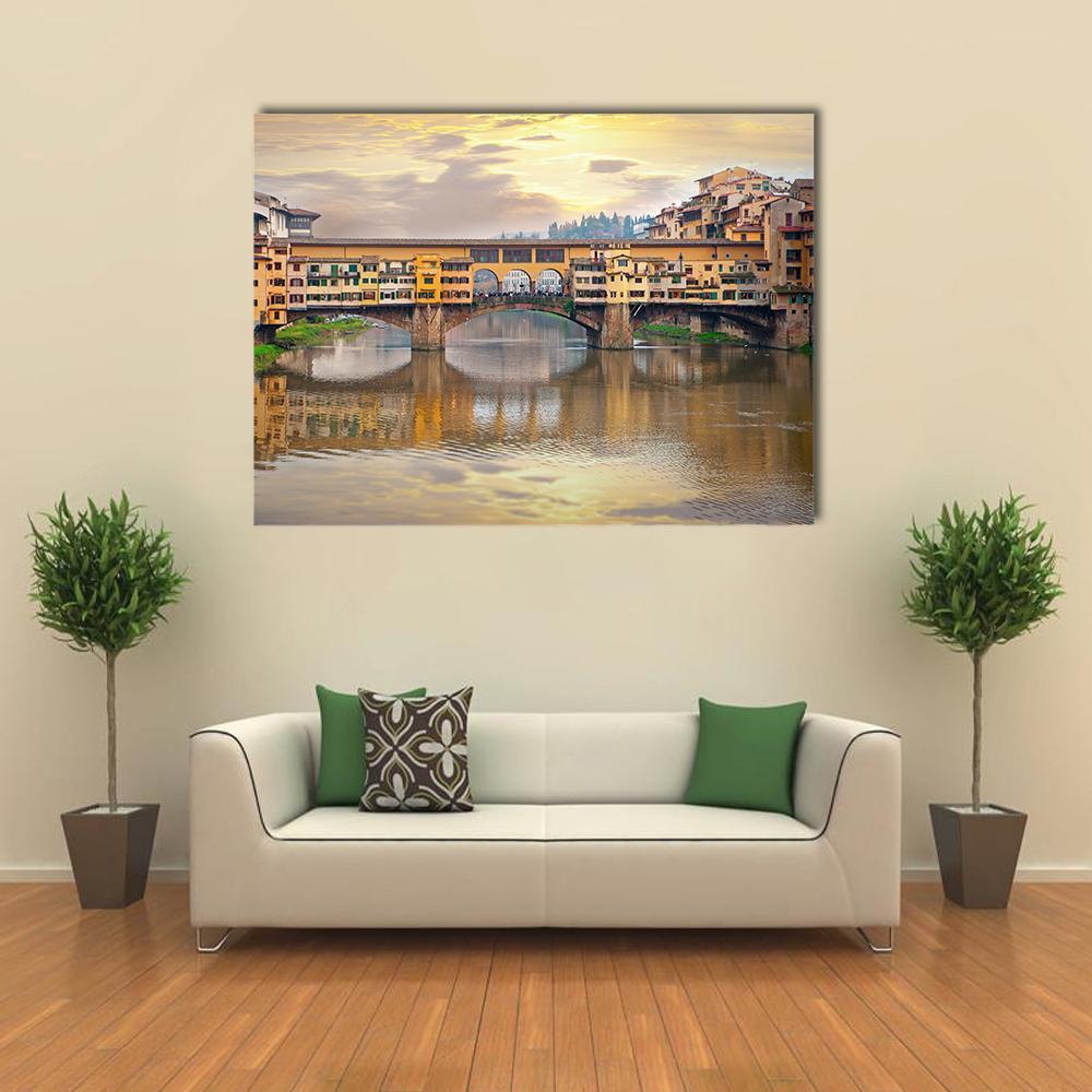 Ponte Vecchio Over the Arno at Golden Hour Canvas Wall Art in brown, gold and yellow, single panel hung on a wall