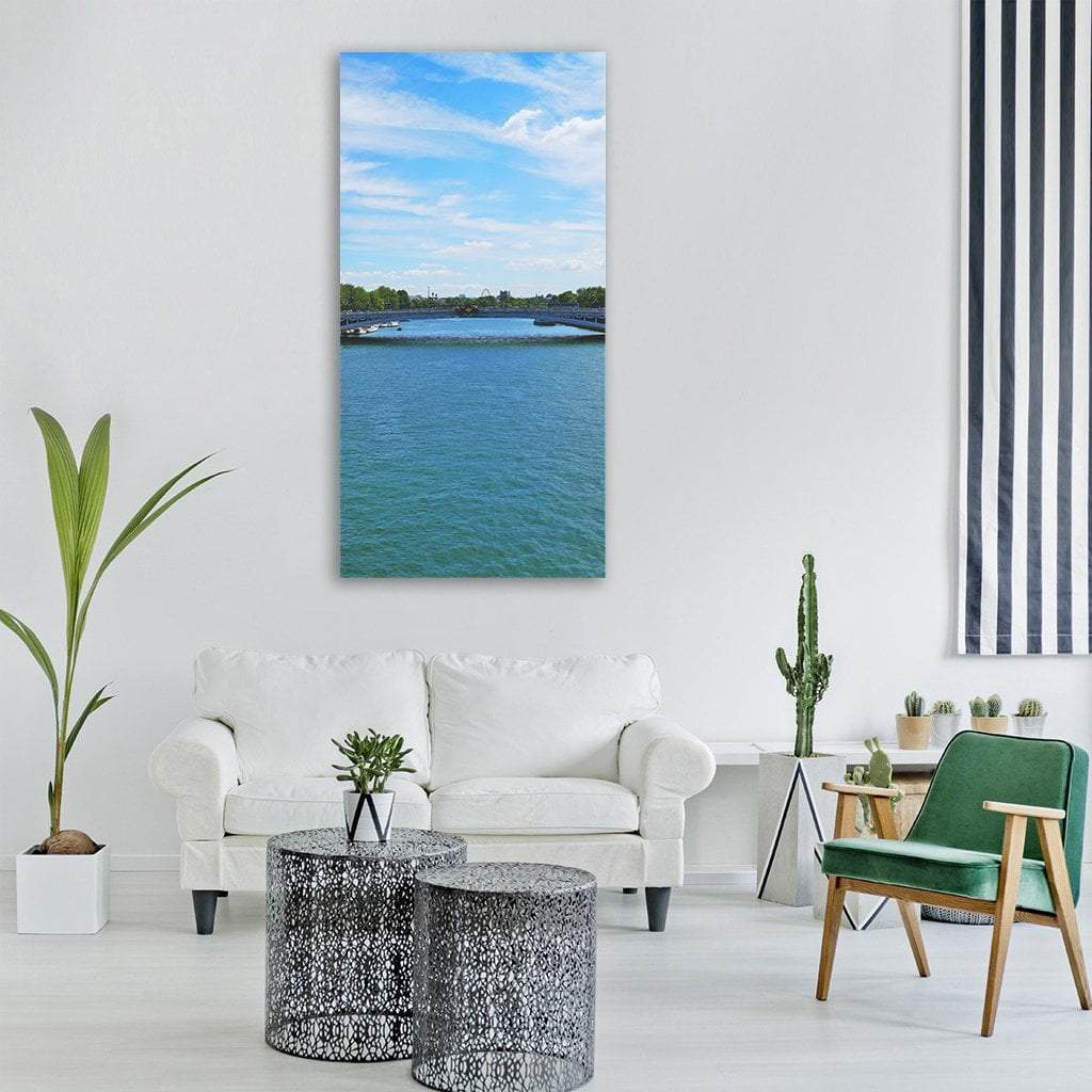 Arched Stone Bridge Over Teal River Vertical Canvas Wall Art in white, green and blue, single vertical panel hung on a wall