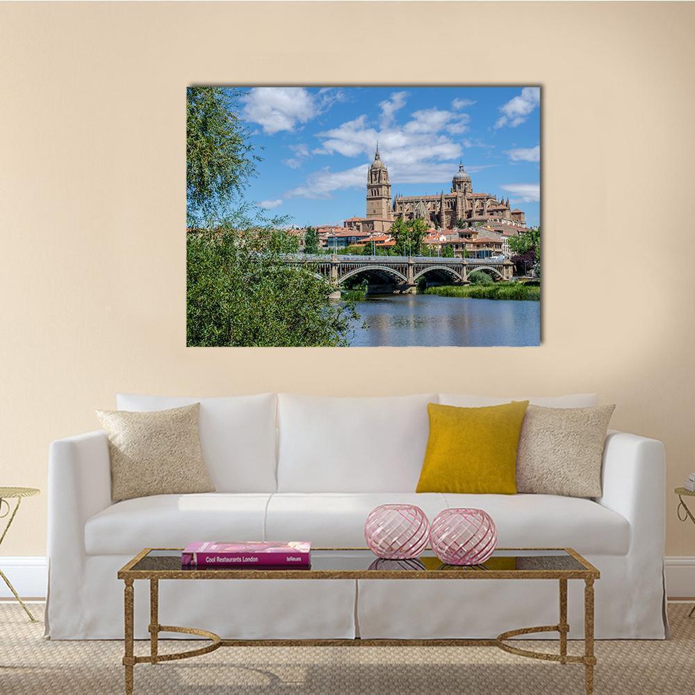 Enrique Estevan Bridge Over the Tormes, Salamanca Cathedral Canvas Wall Art in brown, green and blue, single panel hung on a wall