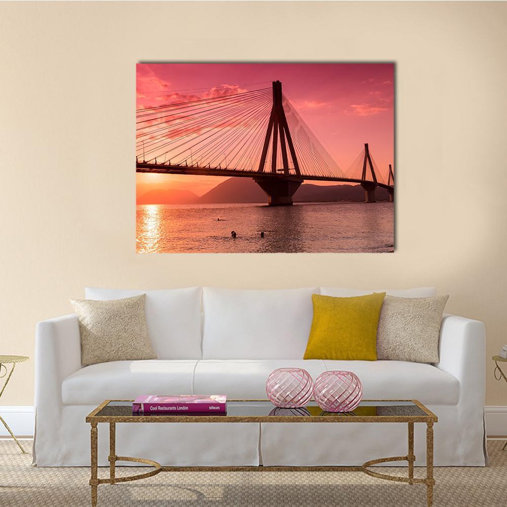 Rio Antirio Bridge at Sunset Canvas Wall Art in red, orange and pink, single panel hung on a wall