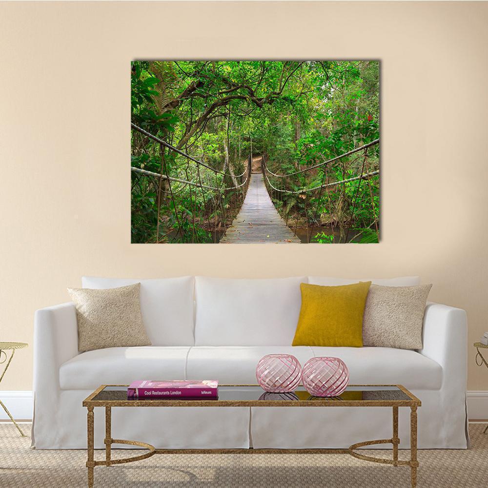 Bridge to the Jungle Canvas Wall Art in brown and green, single panel hung on a wall