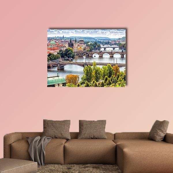 Bridges on the Vltava River Canvas Wall Art in orange, green and blue, single panel hung on a wall
