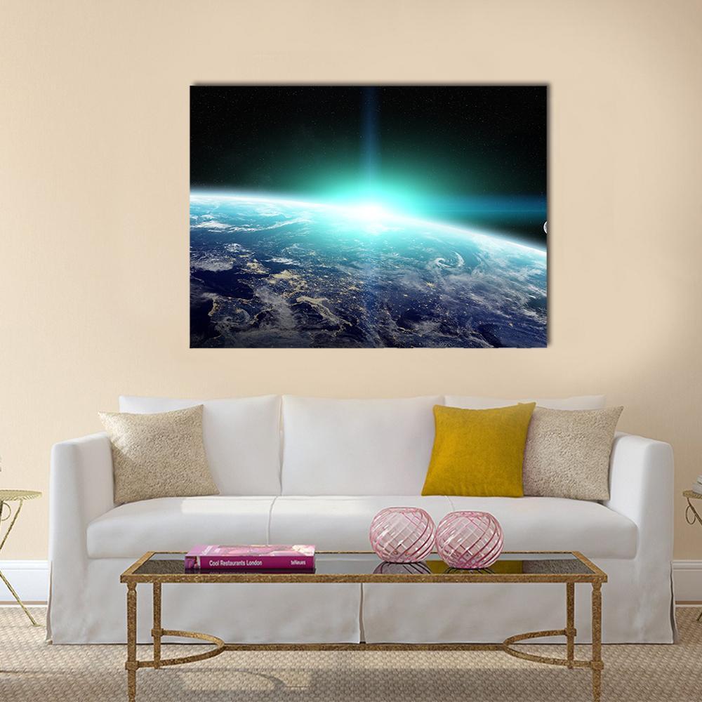 Orbital Sunrise Over Earth Canvas Wall Art in black and blue, single panel hung on a wall