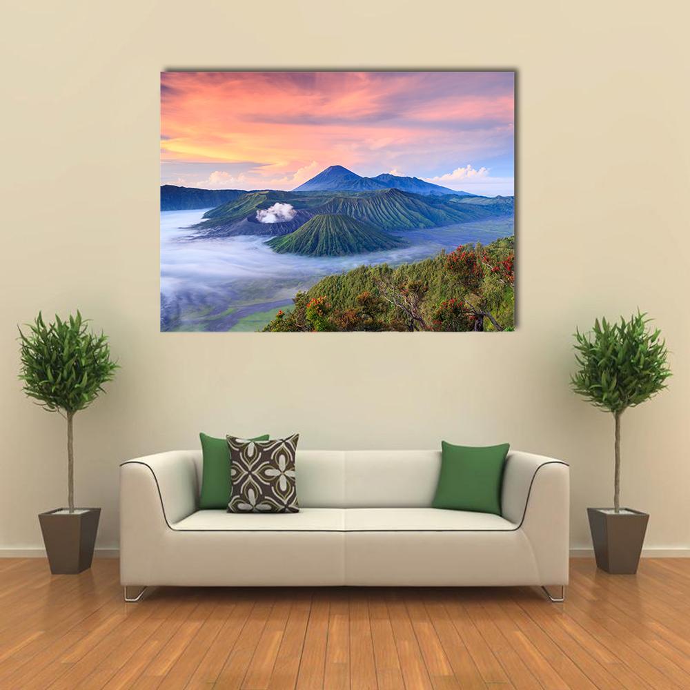 Bromo Volcano Sunrise Over Misty Craters Canvas Wall Art in orange, green and blue, single panel hung on a wall
