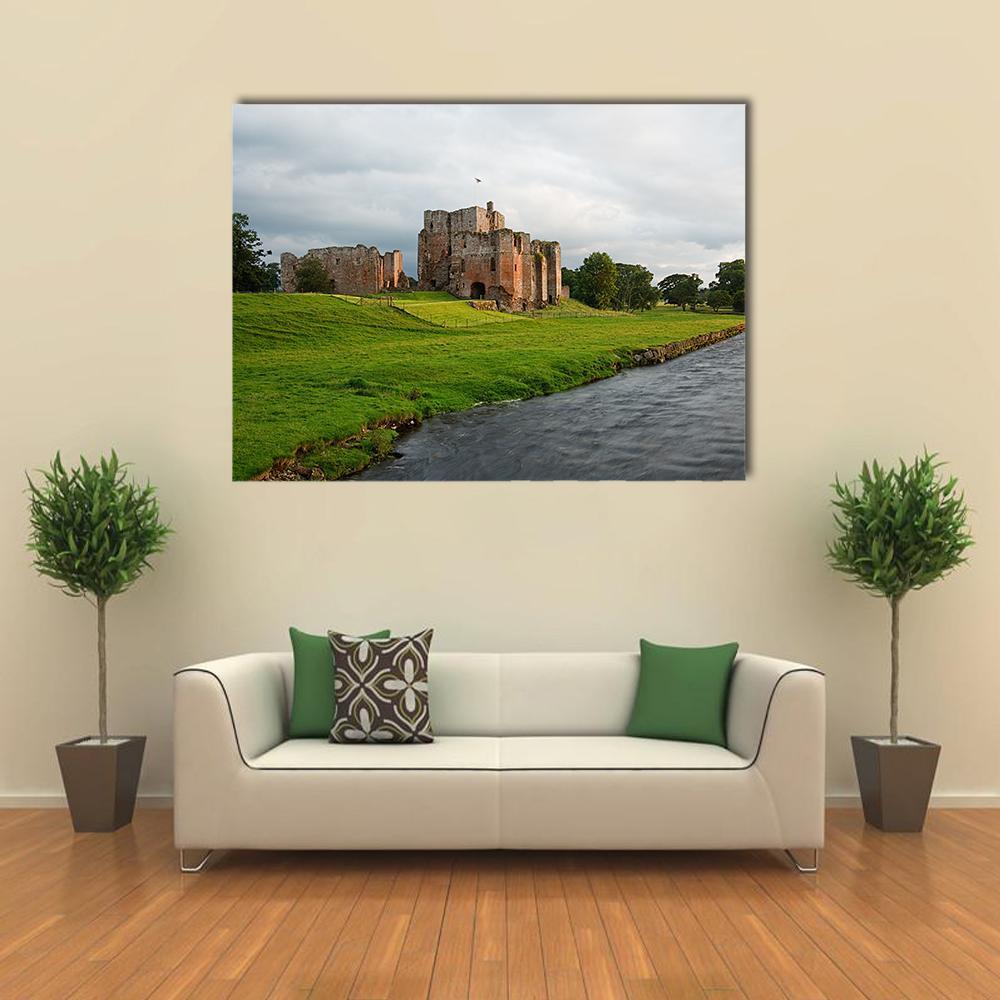 Brougham Castle Ruins Beside River Canvas Wall Art in gray, brown and green, single panel hung on a wall