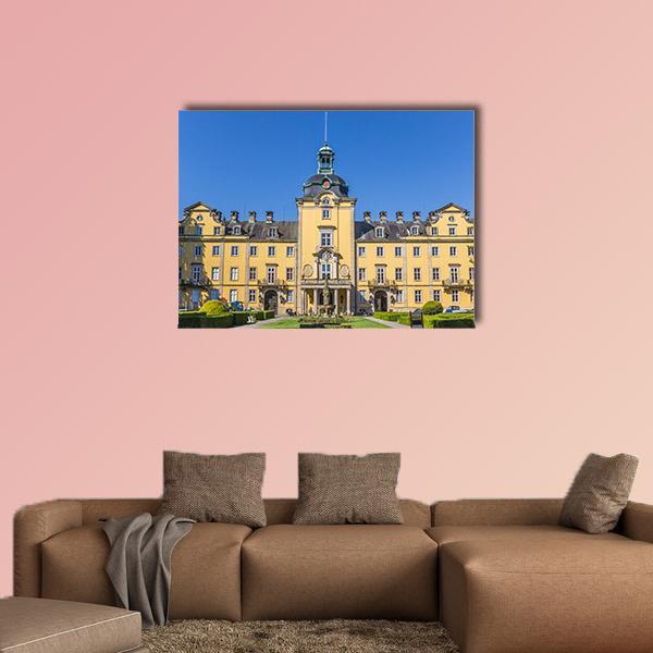 Buckeburg Palace with Manicured Gardens Canvas Wall Art in yellow, green and blue, single panel hung on a wall