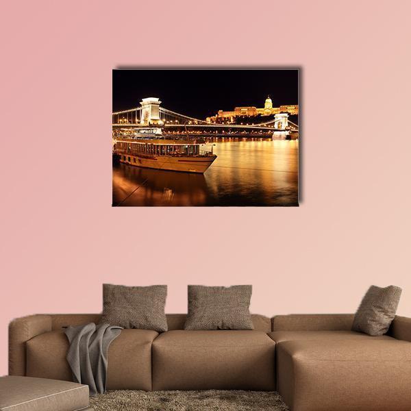Budapest Chain Bridge at Night Canvas Wall Art in black, gold and yellow, single panel hung on a wall