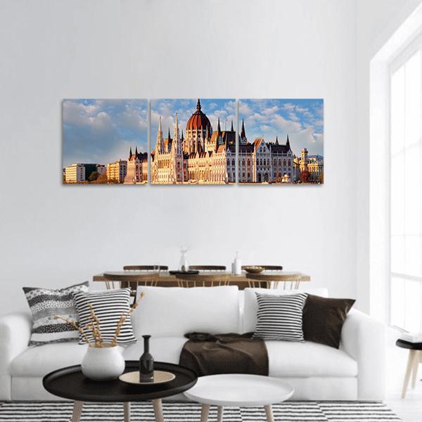 Hungarian Parliament Building at Golden Hour Panoramic Canvas Wall Art in gold, orange and blue, hung on a wall