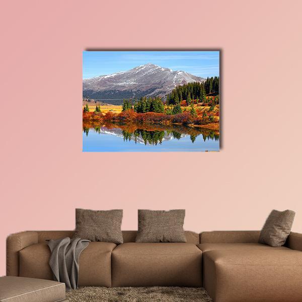 Autumn Lake with Snow-capped Mountain Canvas Wall Art in brown, orange and blue, single panel hung on a wall