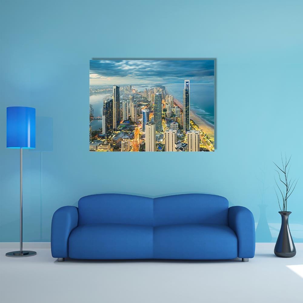 Riverside City Skyline at Twilight Canvas Wall Art in gold, yellow and blue, single panel hung on a wall
