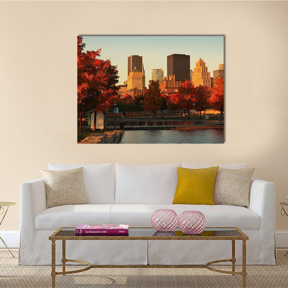 Autumn Riverfront Cityscape with Skyscrapers Canvas Wall Art in red, orange and blue, single panel hung on a wall