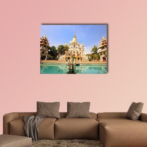 Buu Long Pagoda Canvas Wall Art in beige, gold and blue, single panel hung on a wall