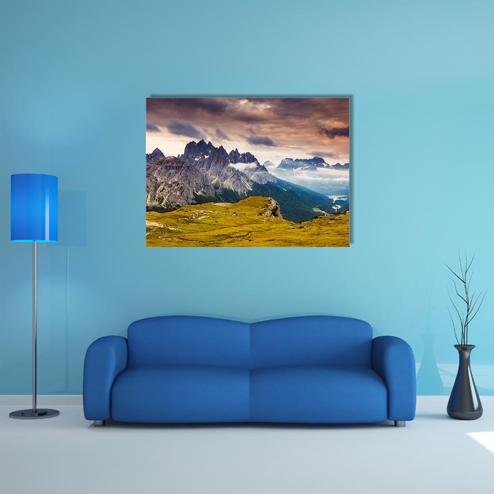 Cadini Di Misurina Sunlit Mountain Peaks Canvas Wall Art in gray, yellow and blue, single panel hung on a wall