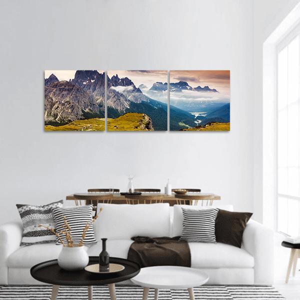 Cadini Di Misurina Mountain Range Panoramic Canvas Wall Art in gray, yellow and blue, hung on a wall