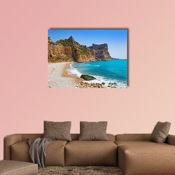 Cala Del Moraig Beach Canvas Wall Art in beige, brown and blue, single panel hung on a wall