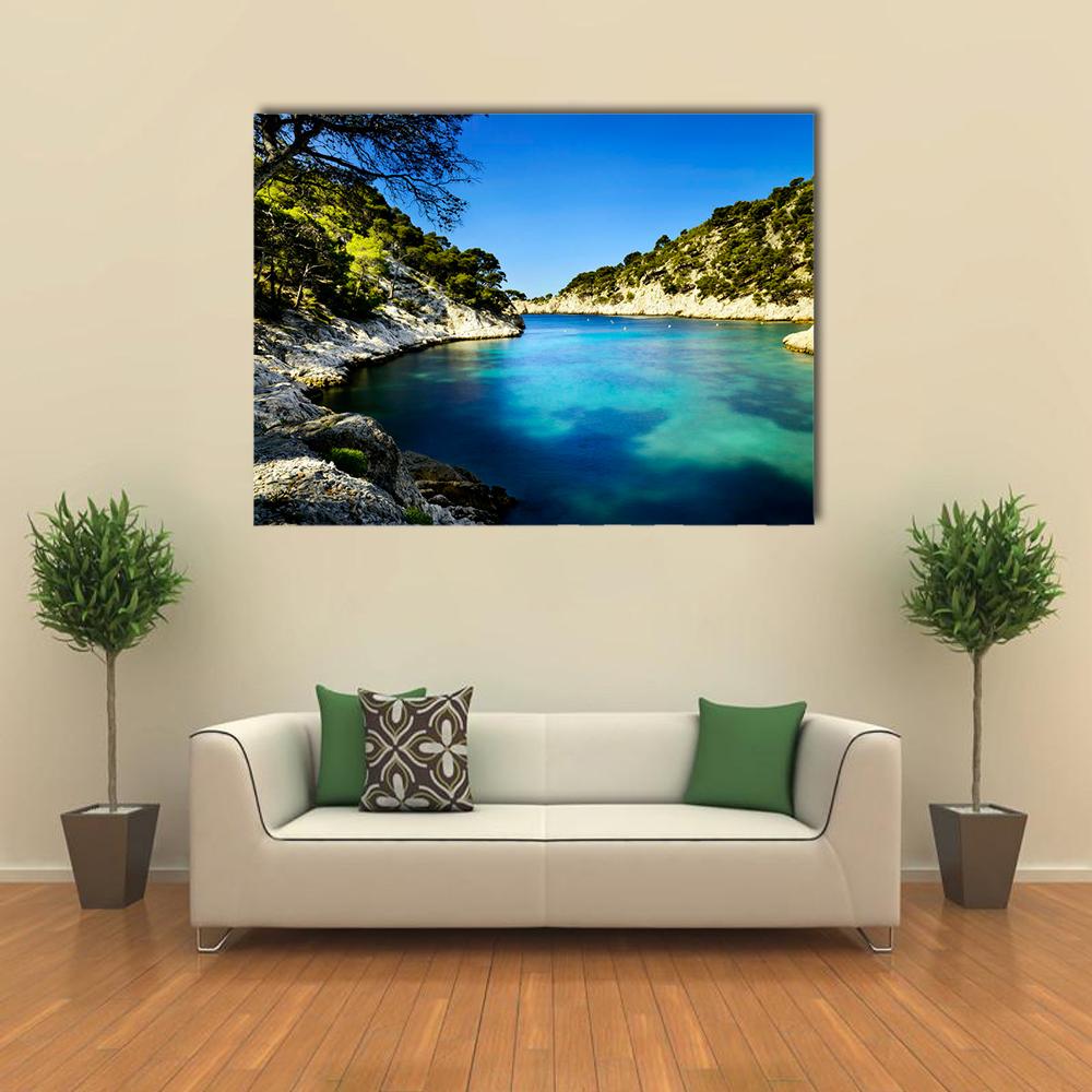 Port Pin Calanque in Cassis Canvas Wall Art in green and blue, single panel hung on a wall