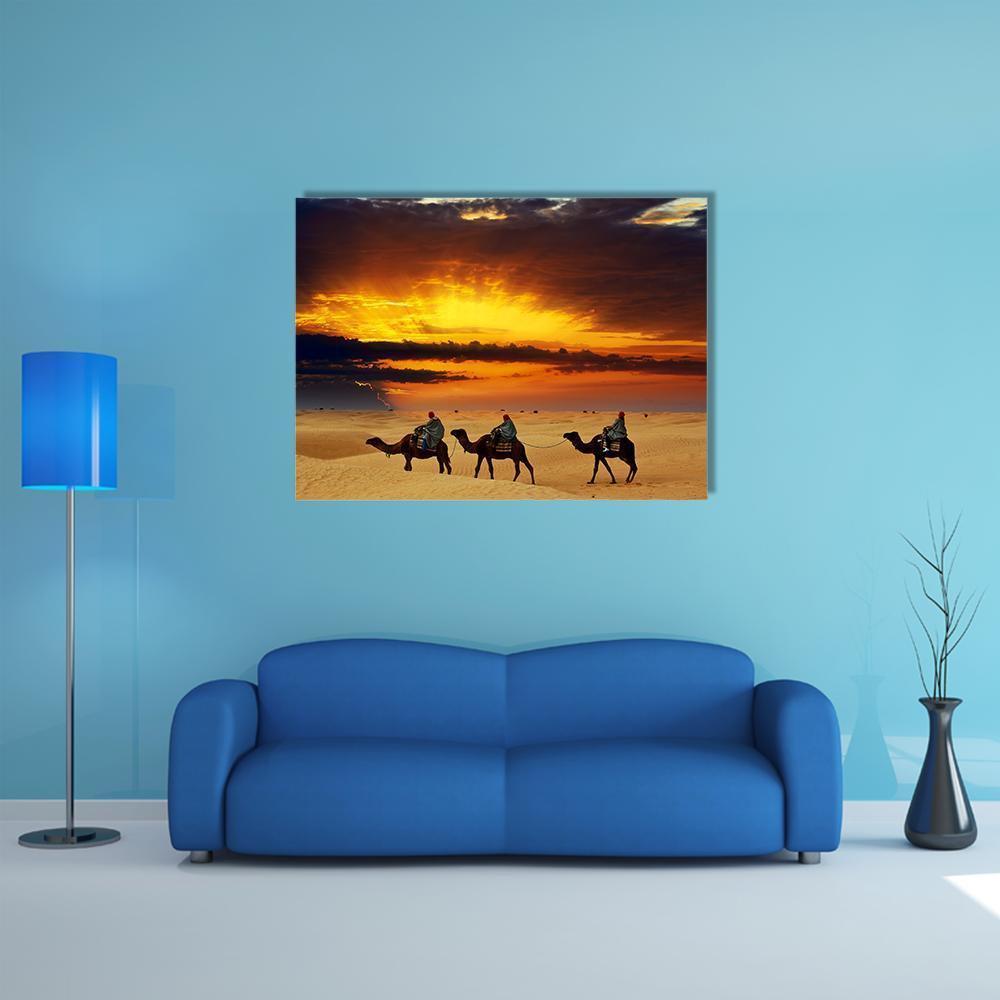 Camel Caravan at Sunset Canvas Wall Art in brown, orange and yellow, single panel hung on a wall
