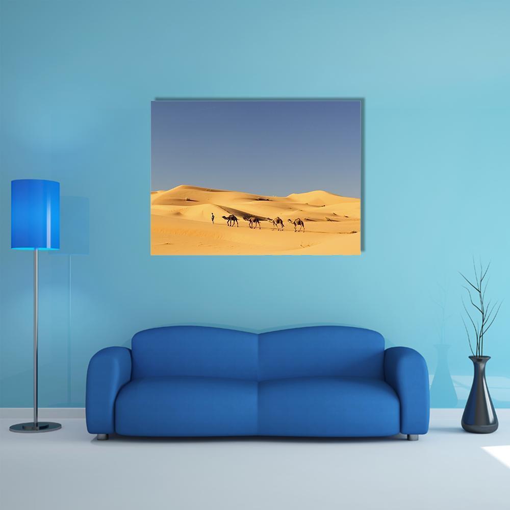 Camel Caravan in Desert Canvas Wall Art in beige, yellow and blue, single panel hung on a wall