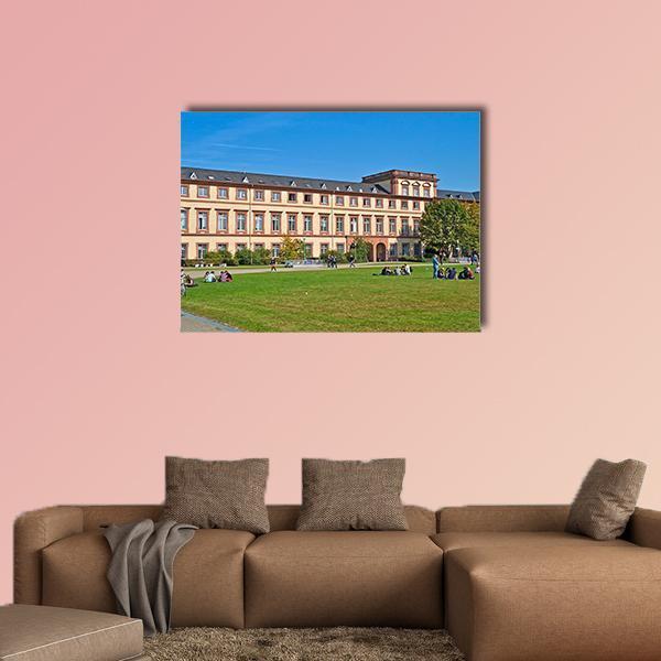 Mannheim University Building on Sunny Lawn Canvas Wall Art in beige, green and blue, single panel hung on a wall