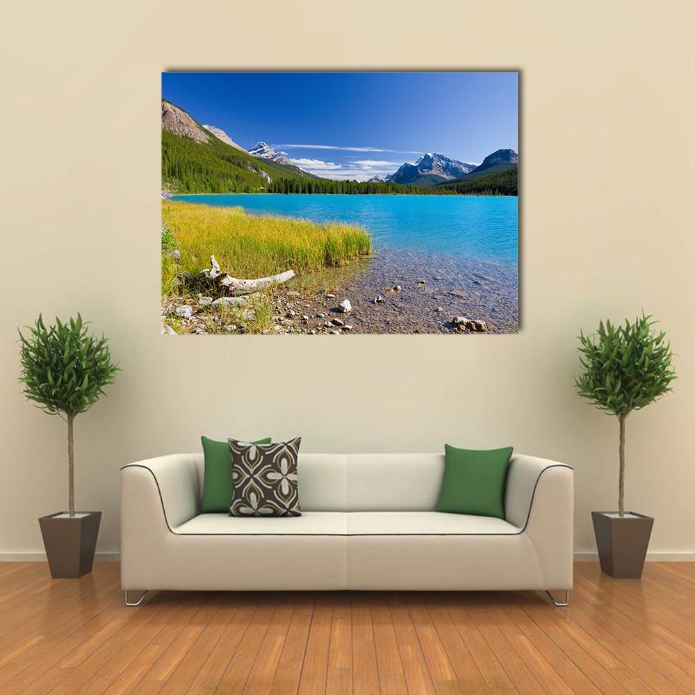 Canadian Mountain Lake with Clear Water Canvas Wall Art in yellow, green and blue, single panel hung on a wall
