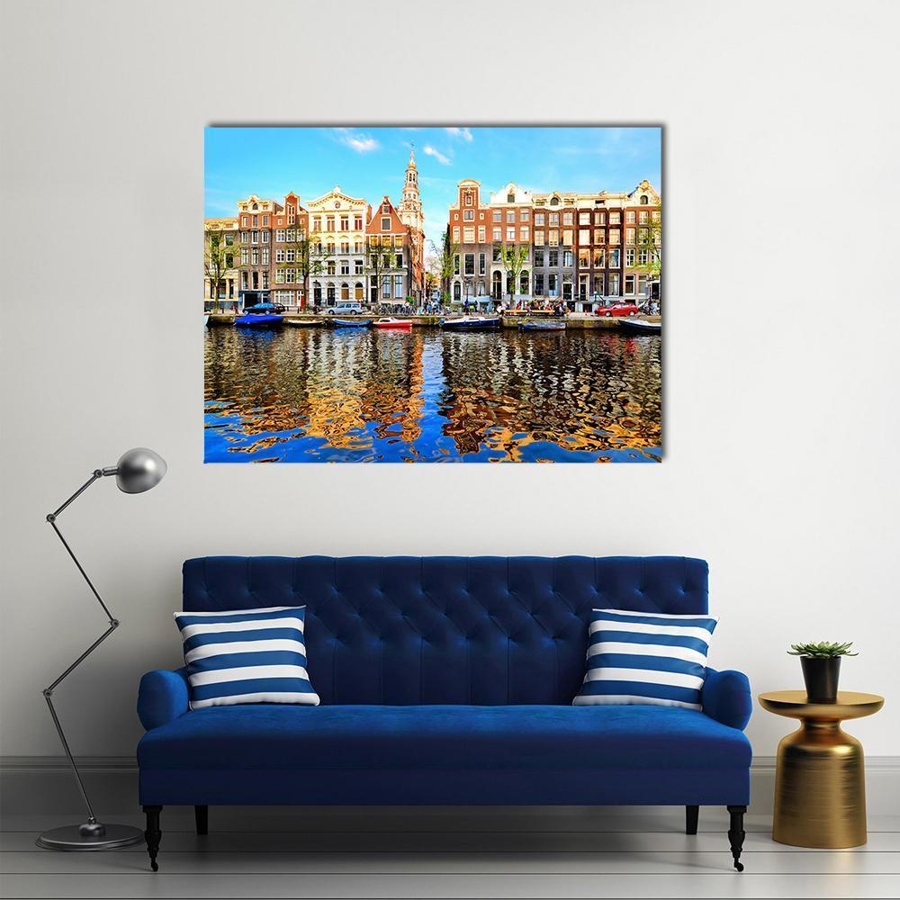 Colorful Canal Houses of Amsterdam Canvas Wall Art in orange, blue and multicolor, single panel hung on a wall